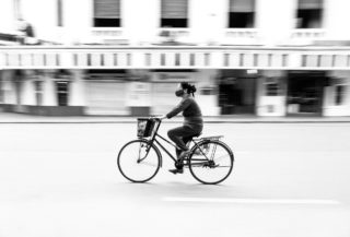Black and White photo by Graeme Heckels Hanoi Street Photography Peddle Bicycle Panning