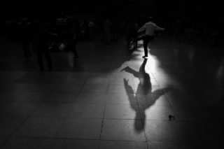 Black and White photo by Graeme Heckels Hanoi Street Photography Shadow Dancer