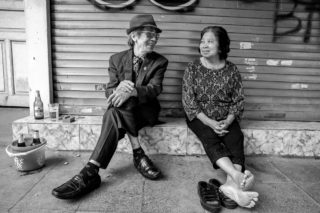 Black and White photo by Graeme Heckels Hanoi Street Photography Loving Couple