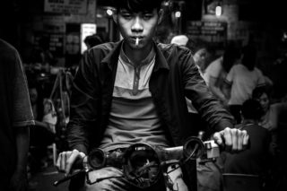 Black and White photo by Graeme Heckels Hanoi Street Photography Tough Guy Portrait
