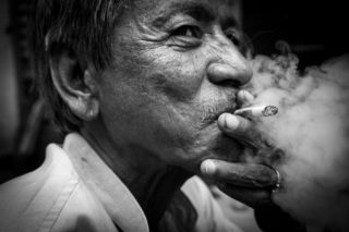 Black and White photo by Graeme Heckels Hanoi Street Photography Pipe Smoker